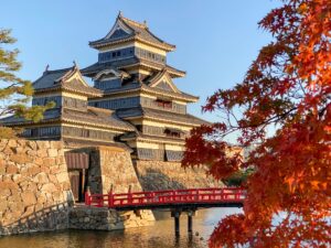 Title Matsumoto Castle with maple leaves in autumn in Nagano, Japan